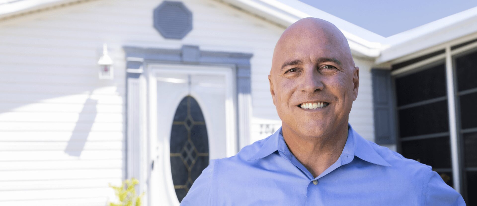 Tom smiling in front of a mobile home