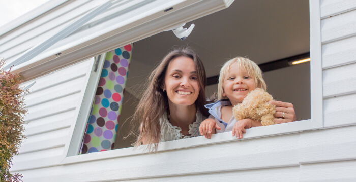 Happy mother and child looking through window